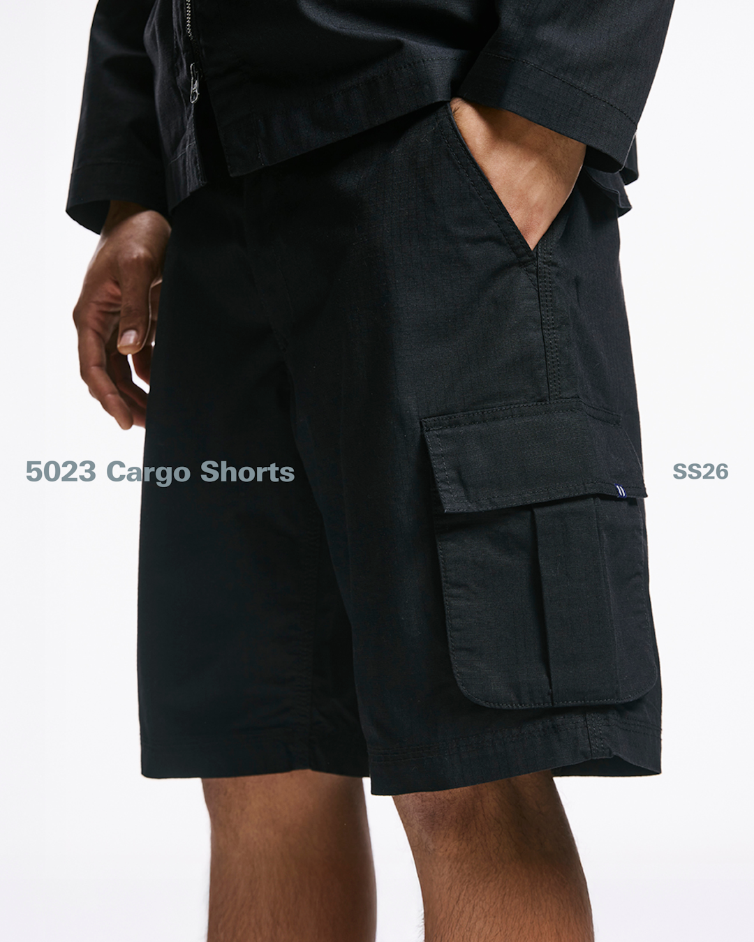 Action shot of a model in a utility field jacket, highlighting the tactical design features.