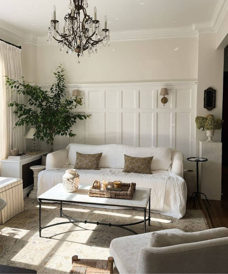 A cozy, styled apartment corner showing the lived-in Nancy Meyers aesthetic.
