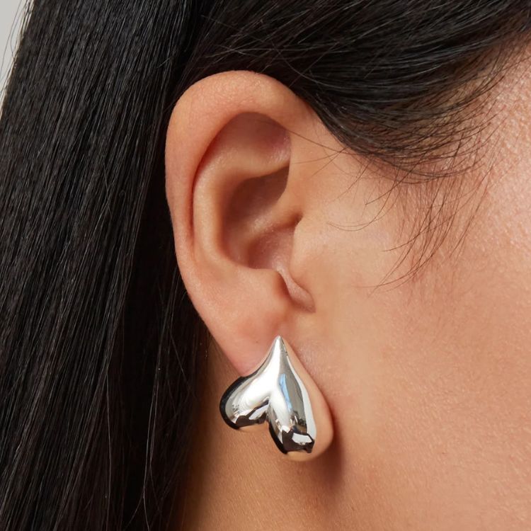 Close-up of Jenny Bird Heart Button Earrings.