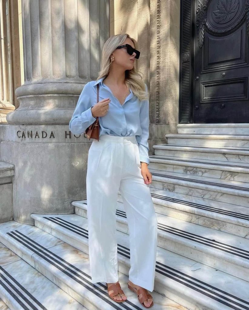 A woman wearing a matching waistcoat and wide leg pants set.