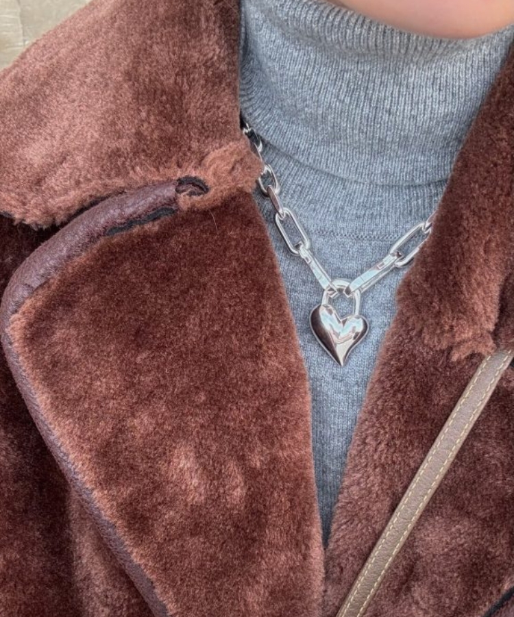 Madeline Galassi wearing layered gold jewelry.
