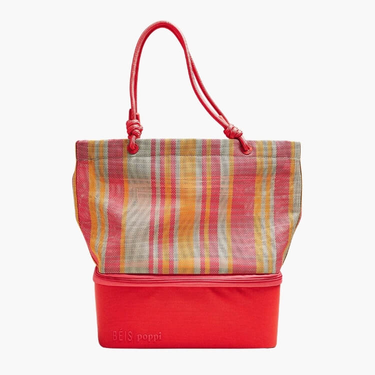 A striped woven Béis x poppi cooler tote with an insulated red base.