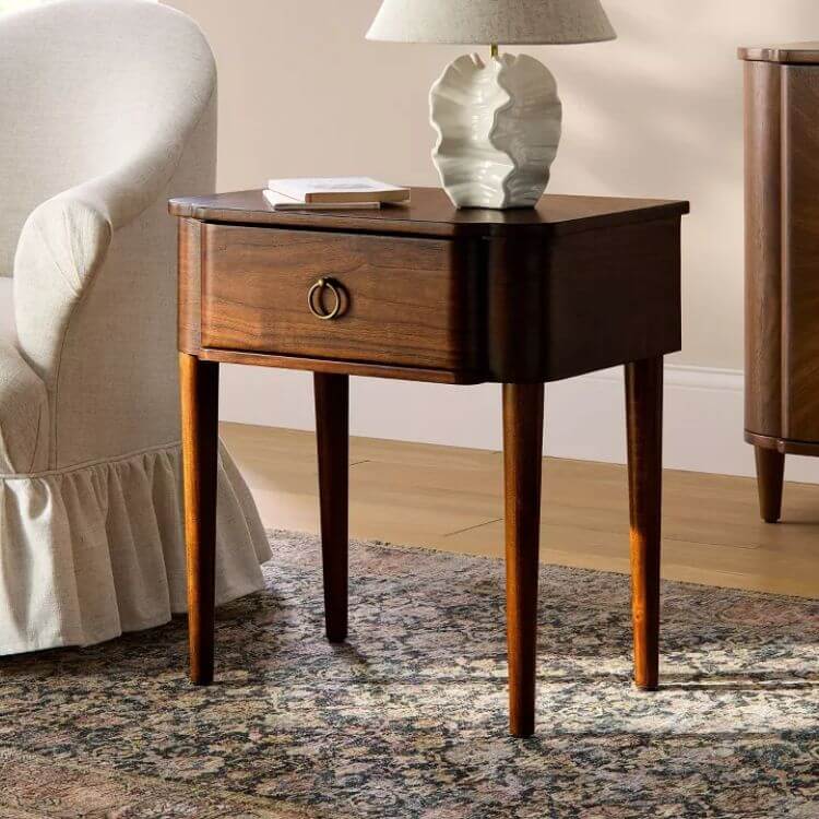 Small walnut wood accent table with a single drawer and metal pull.