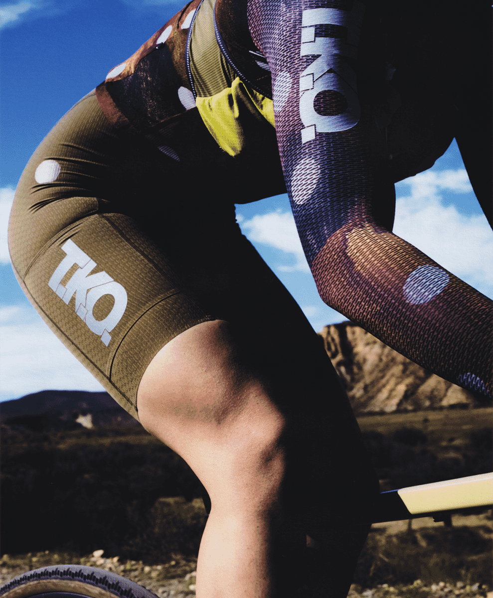 Action shot of a runner transitioning across mixed-terrain surfaces.
