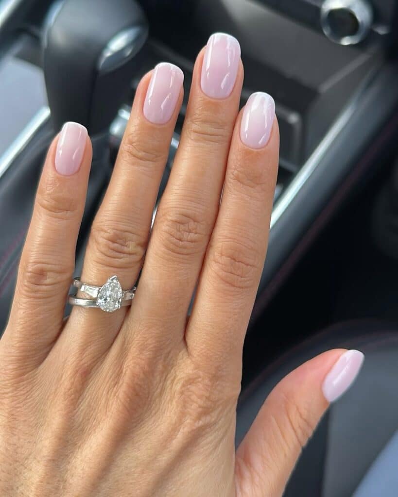 Almond-shaped nails in a warm neutral cream color.