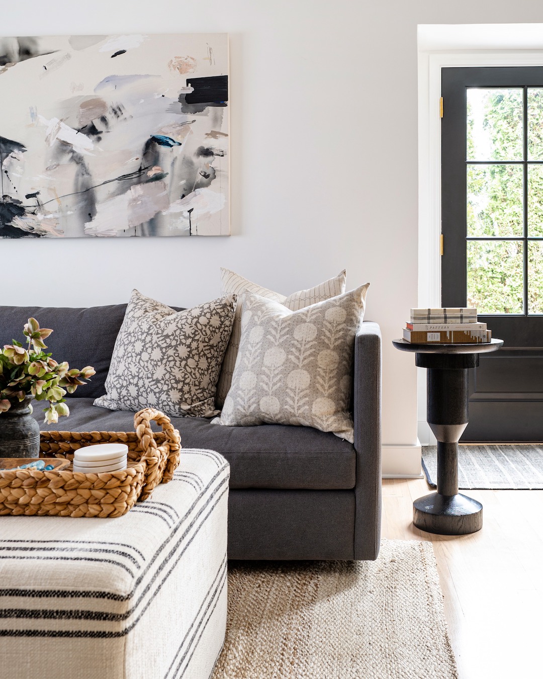 A curated living room interior showing layered linen pillows and soft textiles.