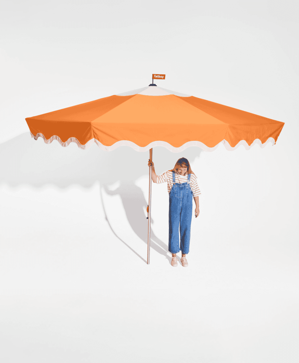 A Fatboy Pensol Parasol casting a soft shadow over garden chairs.