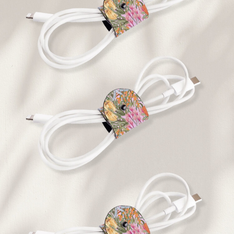 Leather cable wrap organizer holding coiled charging cables