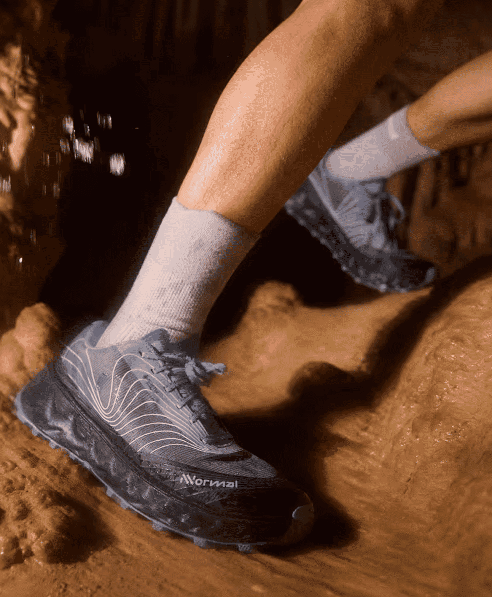 Side profile of a technical NNormal sneaker with visible high-performance cushioning.