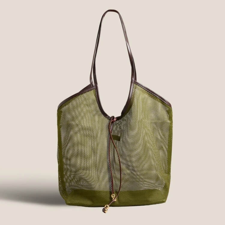 An olive green mesh tote bag with brown leather handles and drawstring closure.