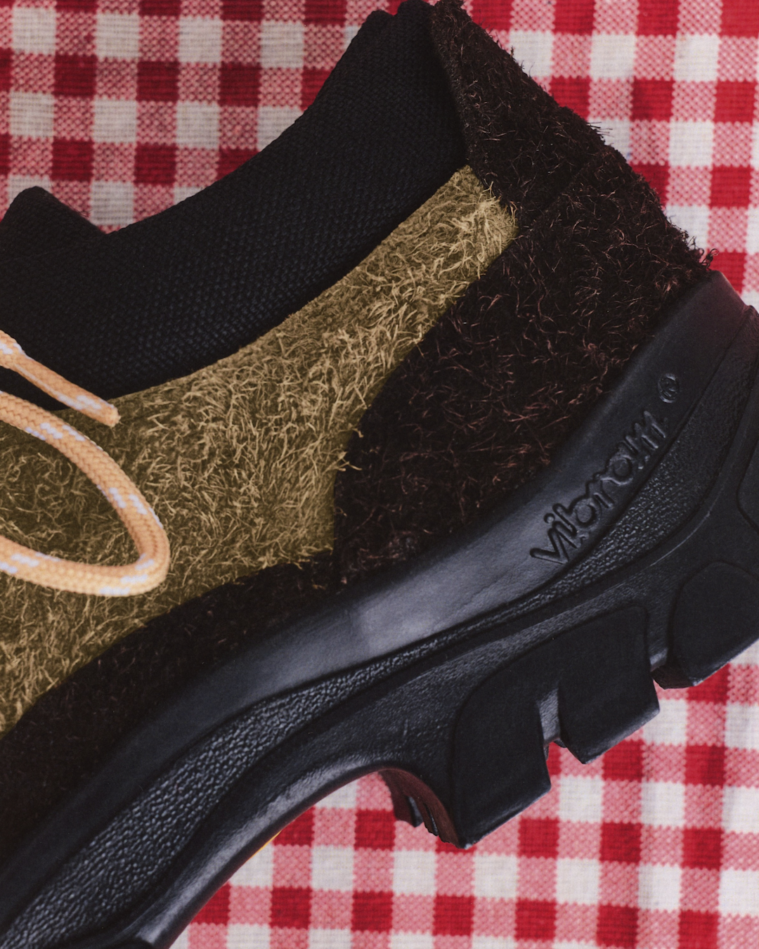 Detailed shot of the hand-finished heel and branding on the Portuguese-made hiking shoes.