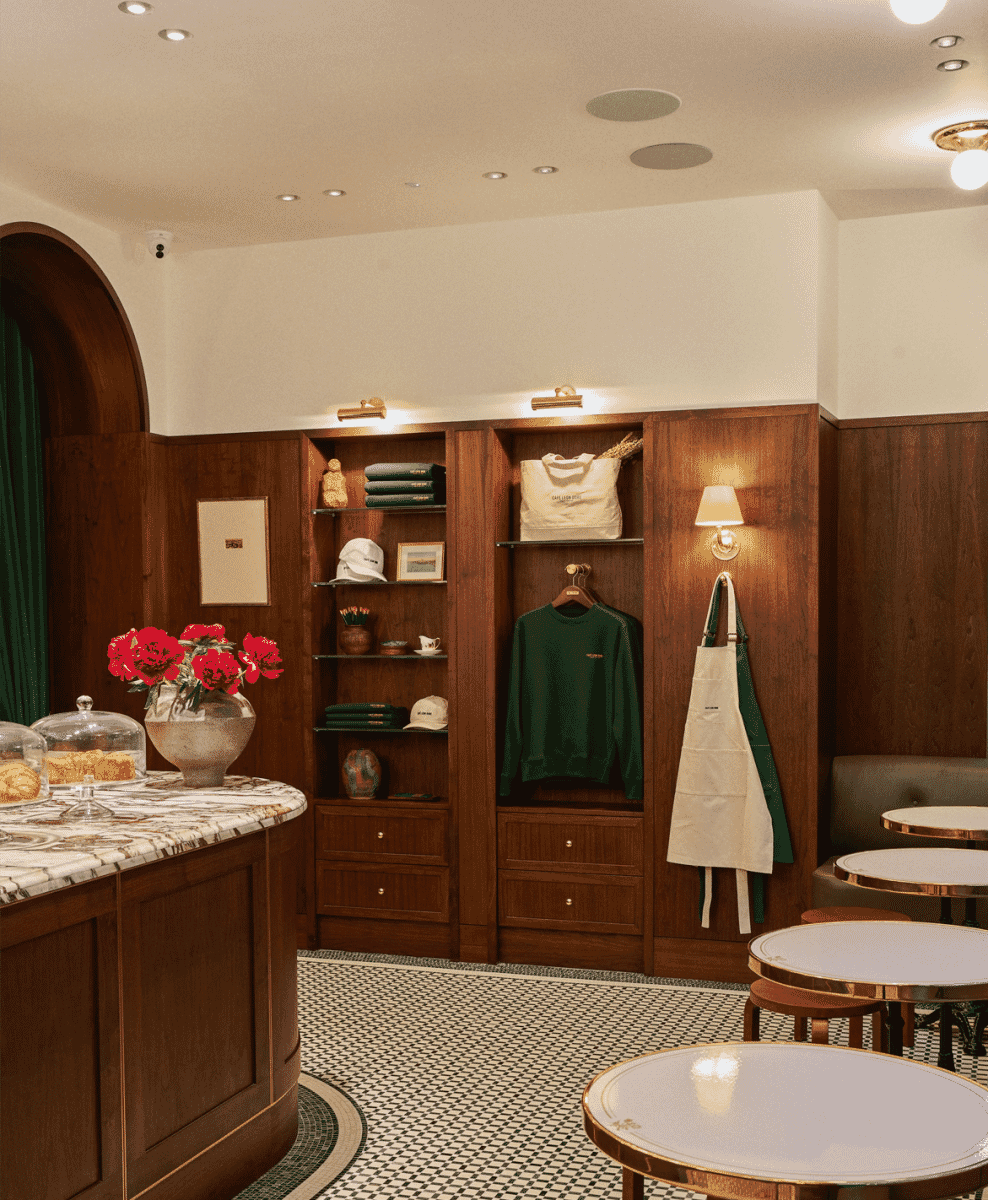 Wood-paneled boutique interior with apparel displays and marble counters.