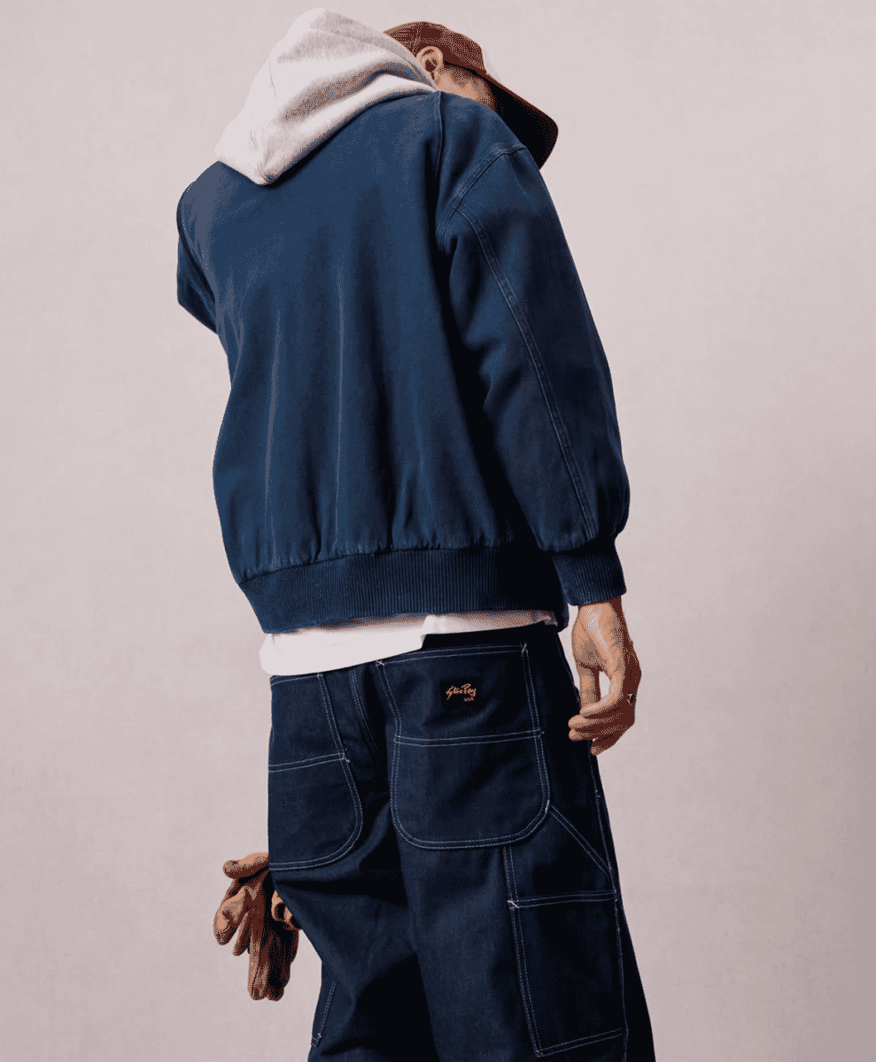 Full lifestyle shot of a model in a complete workwear-inspired outfit.
