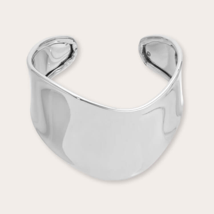 A smooth, minimalist silver cuff bracelet with a high-shine finish.