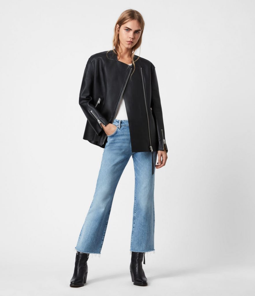 Black leather biker jacket styled with light-wash wide-leg jeans.