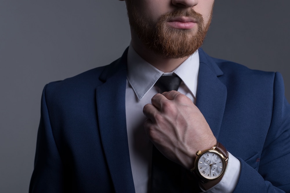 Side view of a luxury watch crown and polished case finish.