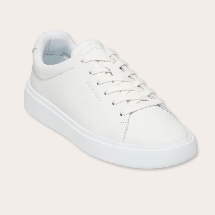 Polished white leather sneakers suitable for professional settings.