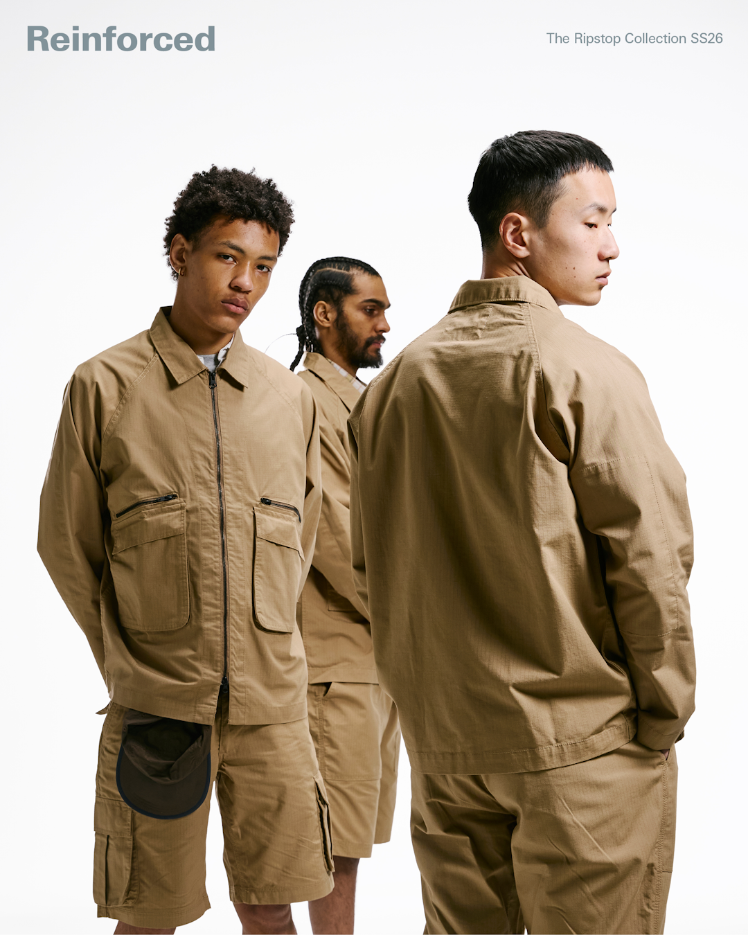 90s style lookbook photograph of a model in utility workwear posing against a neutral backdrop.