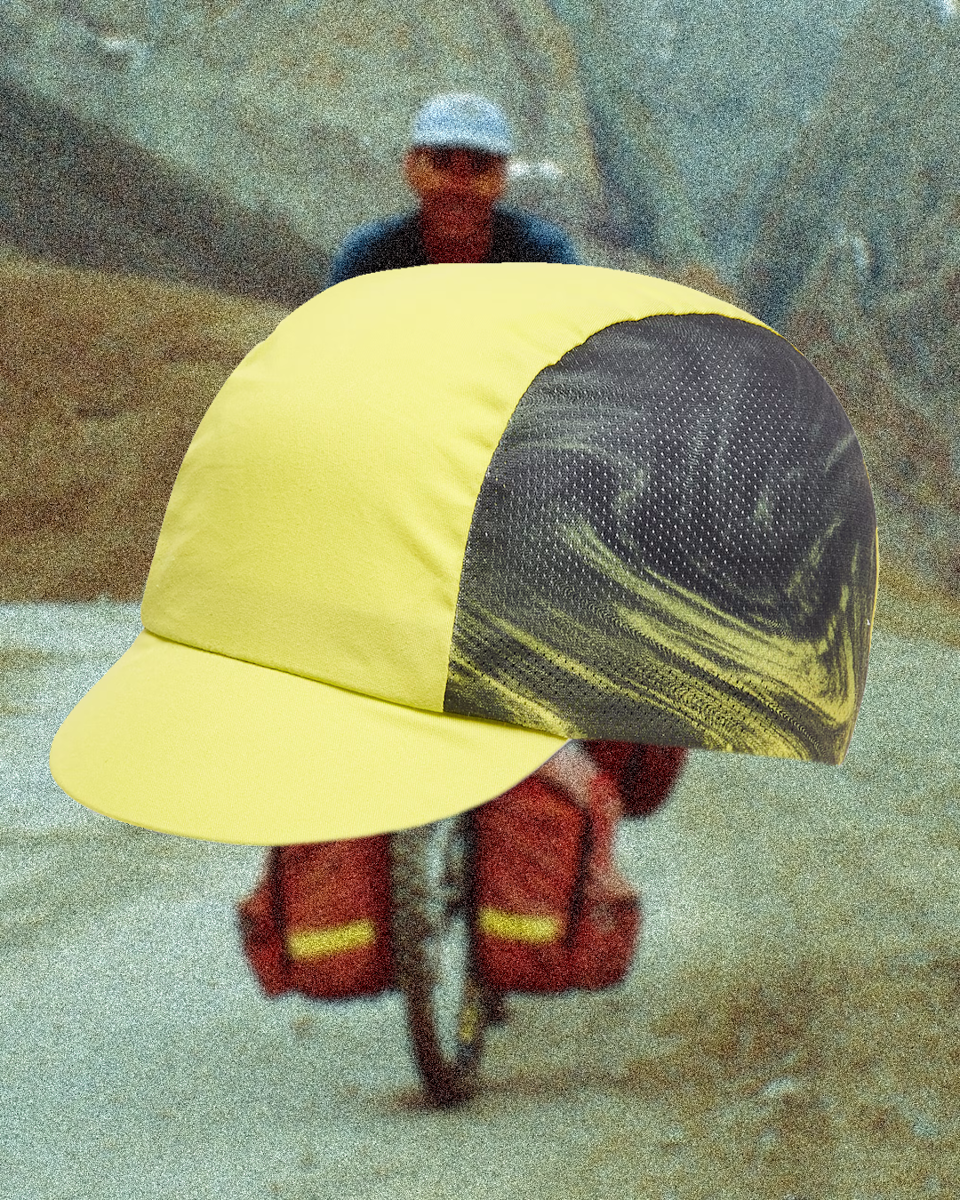 A minimalist butter yellow cycling cap paired with a matching pastel jersey in a clean, high-key studio setting.