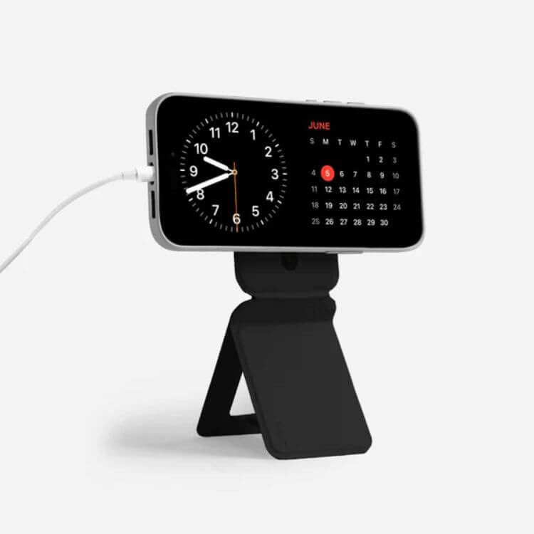 Foldable snap-on phone tripod stand attached to a smartphone