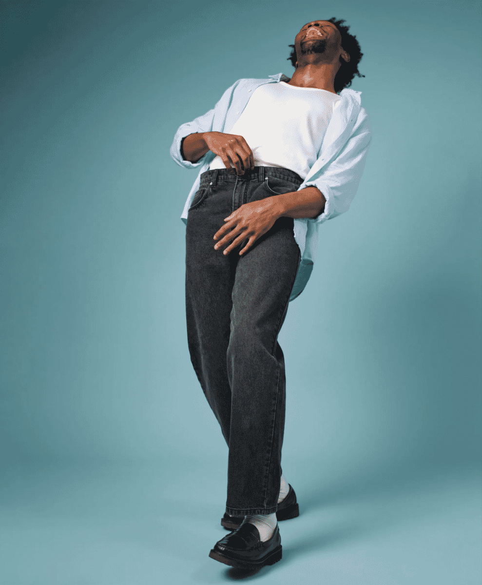 Side view of a man wearing regular straight fit indigo denim jeans.