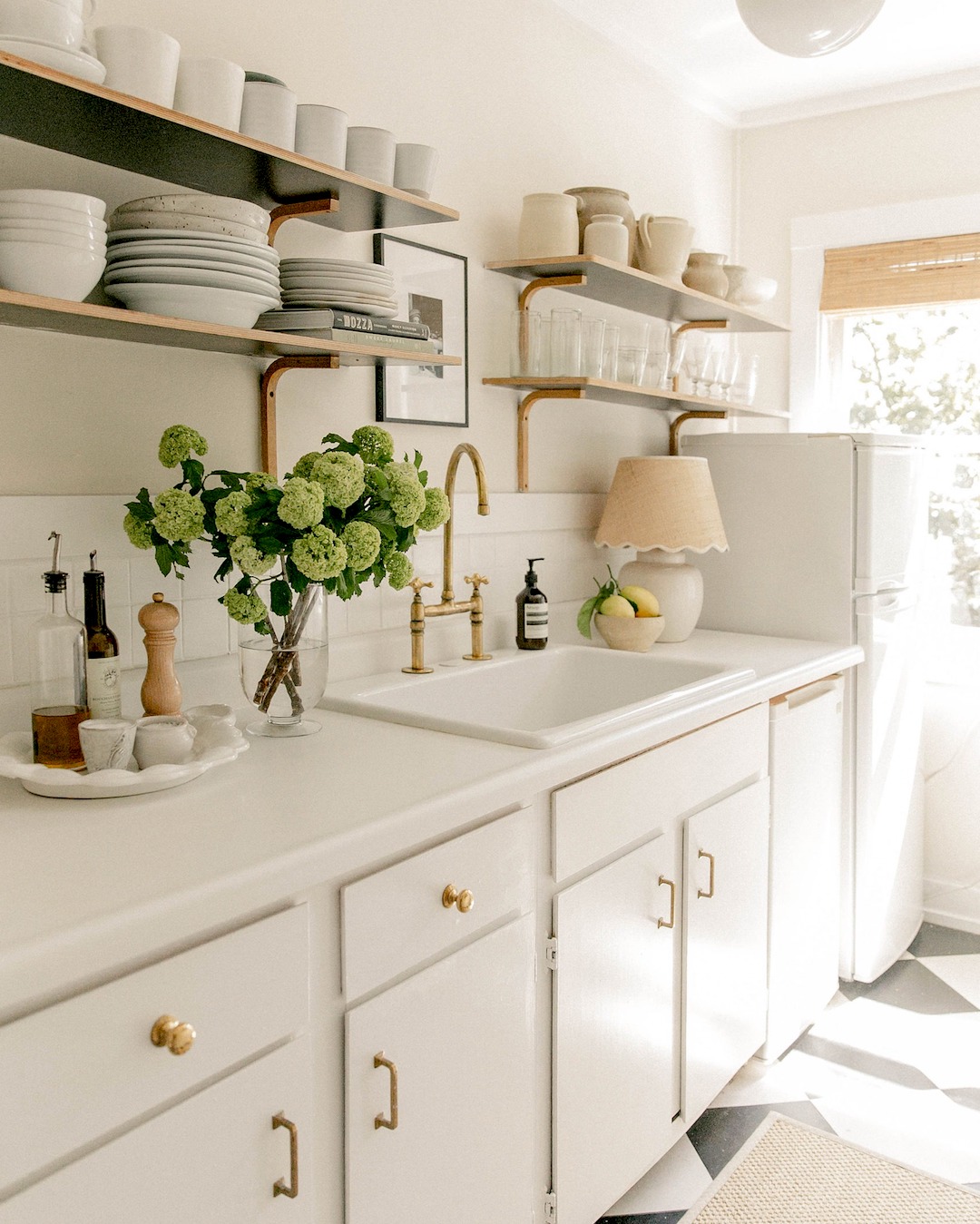 A warm, well-lit kitchen with stoneware accessories and a lived-in feel.