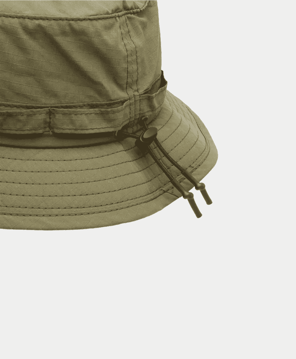 The Beams Plus Hat resting on a wooden garden seat.