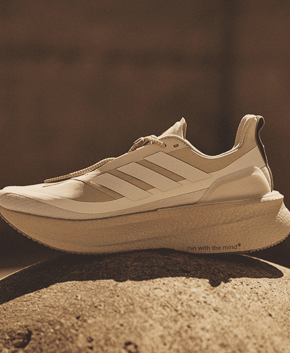 Detail of an Adidas shoe sole with the text 'run with the mind' printed on it.