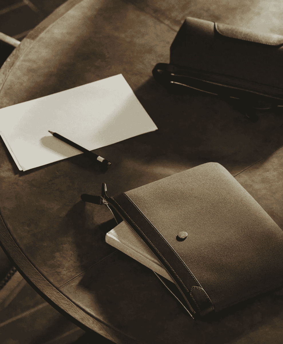 Close-up of a canvas and leather briefcase with hand-polished brass hardware.