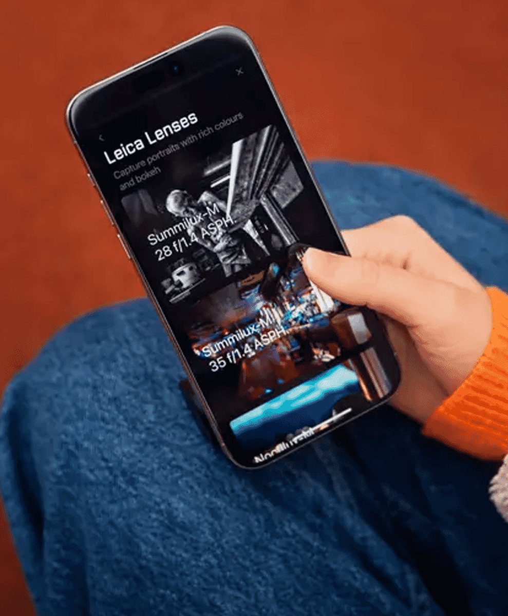 A smartphone displaying Leica Summilux lens simulations on its screen.