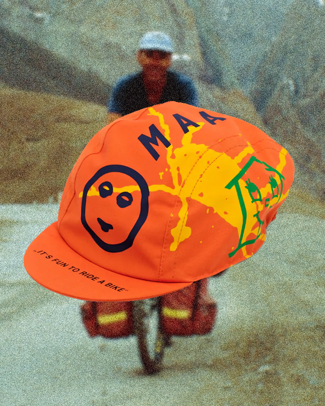 A four-panel cotton cycling cap featuring classic retro typography and red and blue heritage racing stripes.
