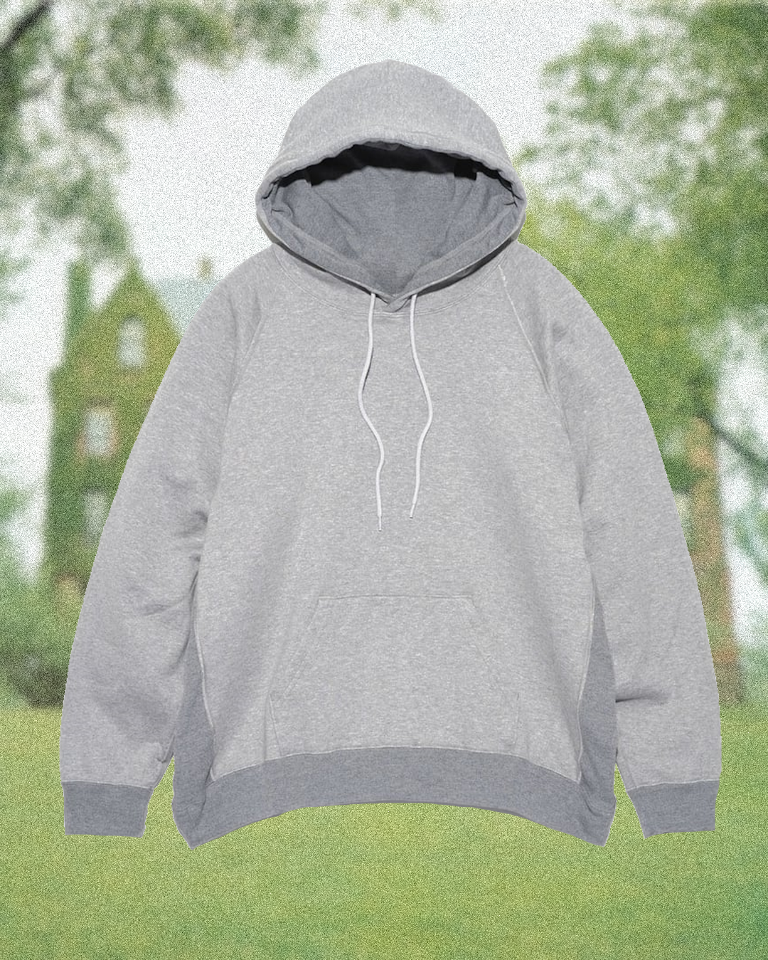 Water droplets beading off the surface of a grey marl Carhartt hoodie in an outdoor setting.