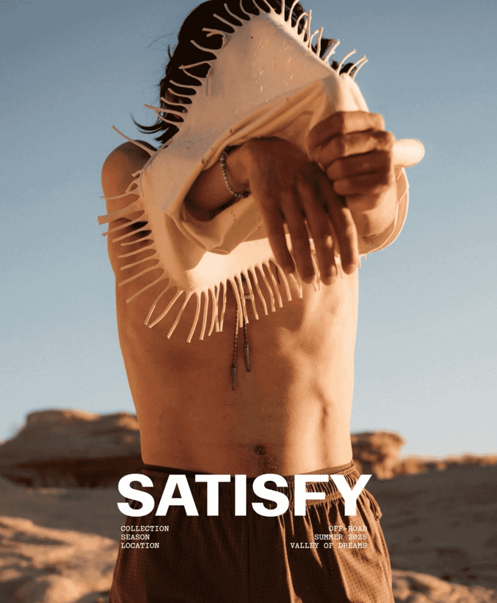 A man in the desert wearing brown perforated shorts and fringed gear from the Satisfy Off-Road collection.