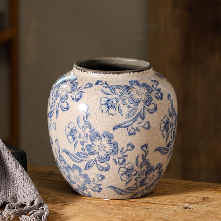 Blue and white floral ceramic vase styled on a surface.
