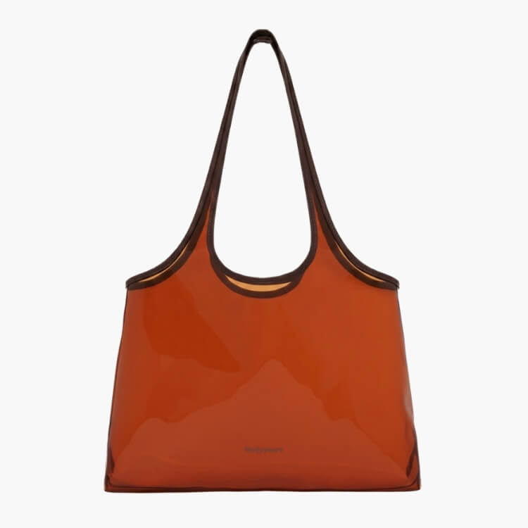 A translucent amber jelly tote bag with brown handles and minimalist branding.