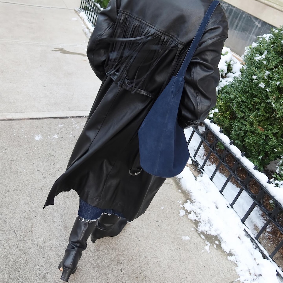Influencer style shot of the J.Crew bucket bag used for a review.