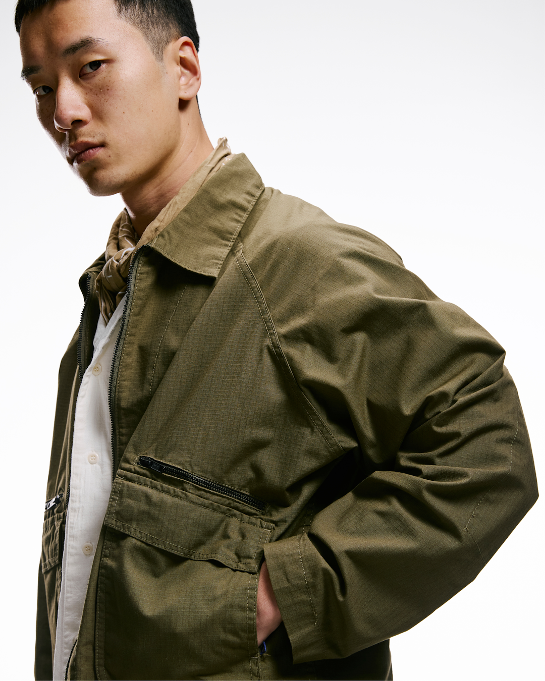 Workwear garment displayed within a creative studio environment to show industrial utility.