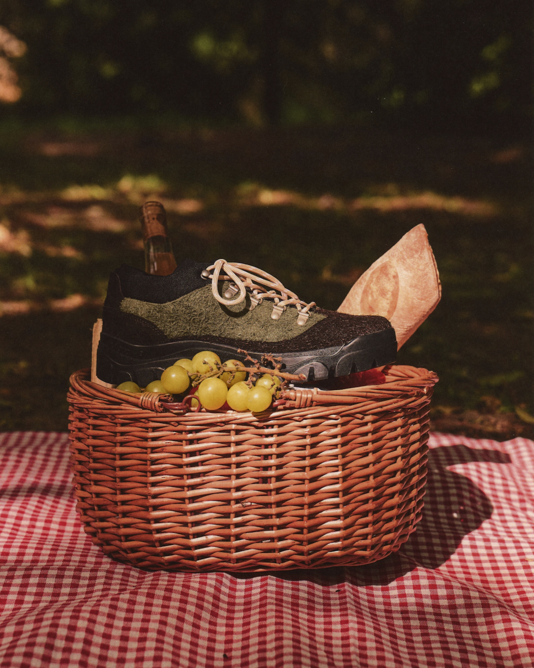 Lifestyle photo of a person wearing Big Cheese hiking shoes with technical trousers in an urban park.
