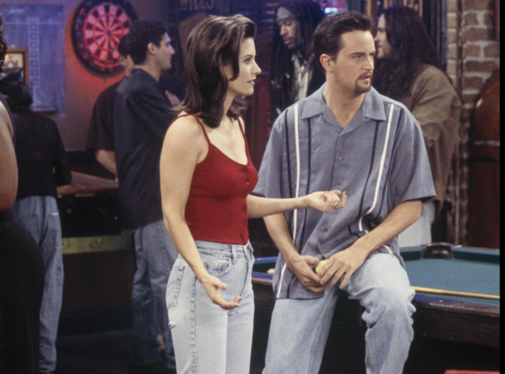 Monica Geller in her iconic high-waisted mom jeans and a red tank top.