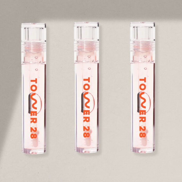 Tube of clear jelly lip gloss on a desk