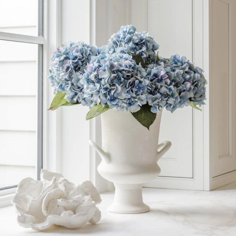 Vibrant Nantucket blue hydrangea stems in a vase.