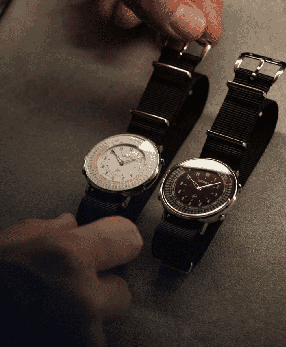 Close-up of the watch dial showing the Fragment lightning bolt logo and monochrome layout.