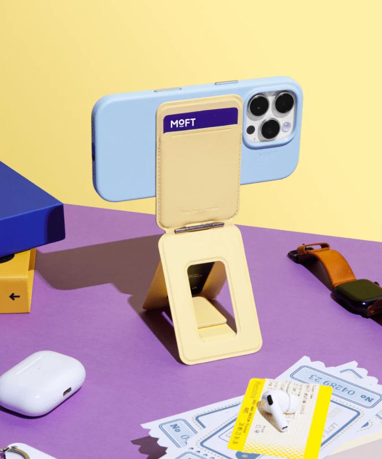 An iPhone elevated on a magnetic tripod stand for a video call.
