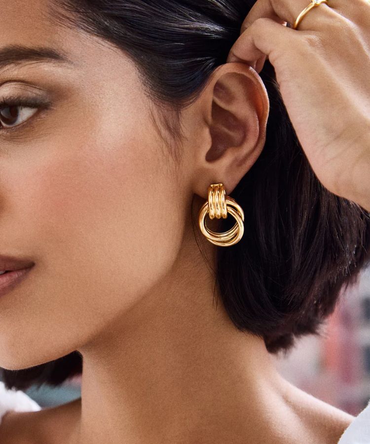 Gold hoop or stud earrings.