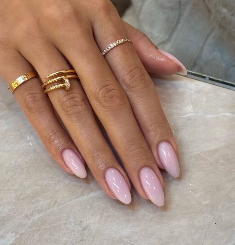 Extreme close-up of a perfectly maintained cuticle and high-shine nail surface.
