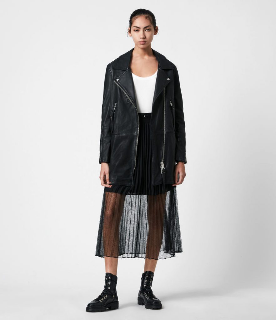 Leather biker jacket paired with a black pleated mesh skirt.