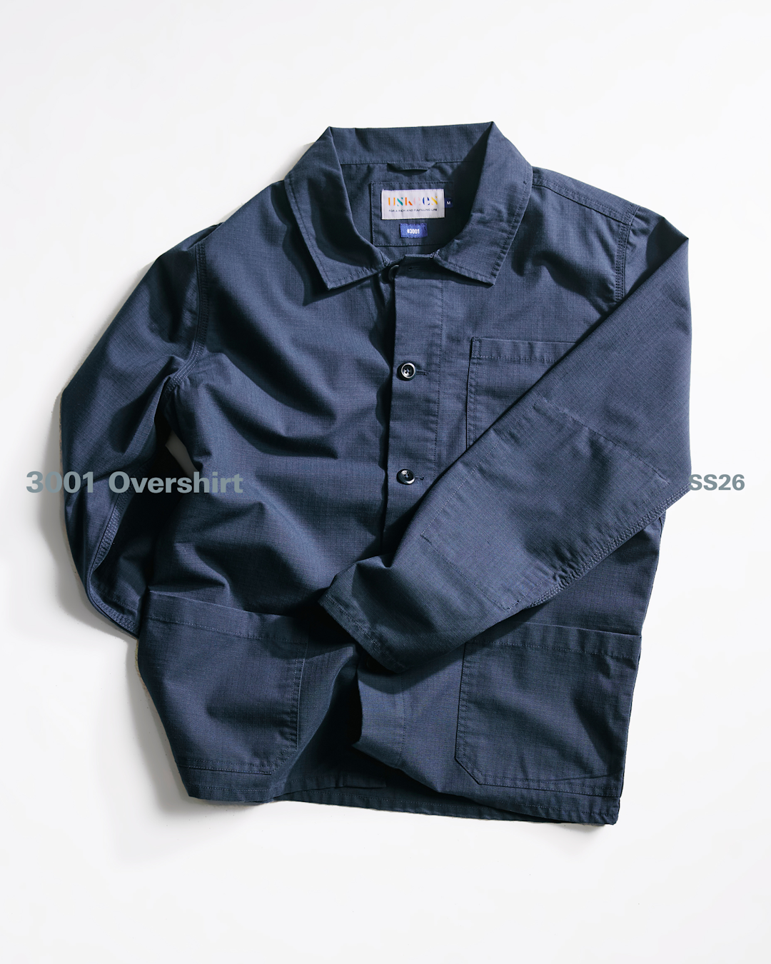 Model wearing high-performance workwear staples in a lifestyle setting.