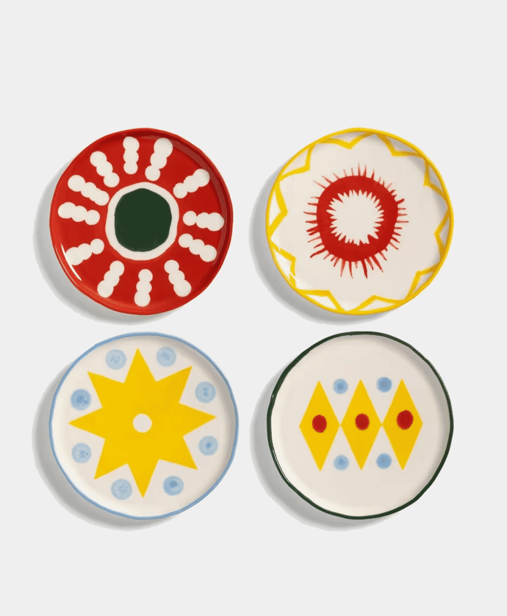 A stack of &Klevering Small Plates with colorful patterns.