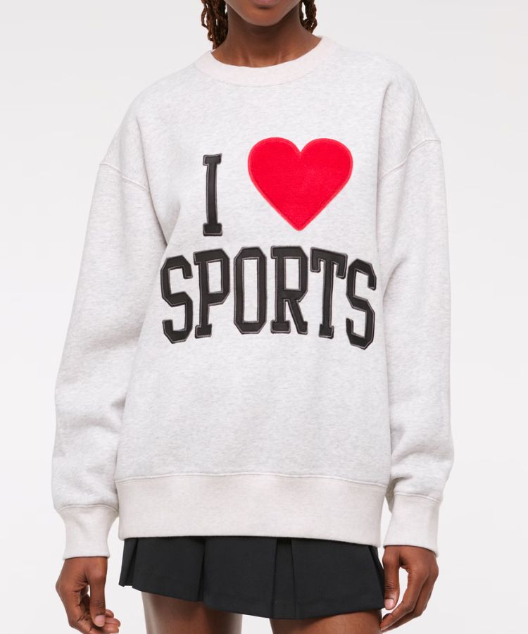 Grey crew neck sweatshirt with vintage-style sports lettering.