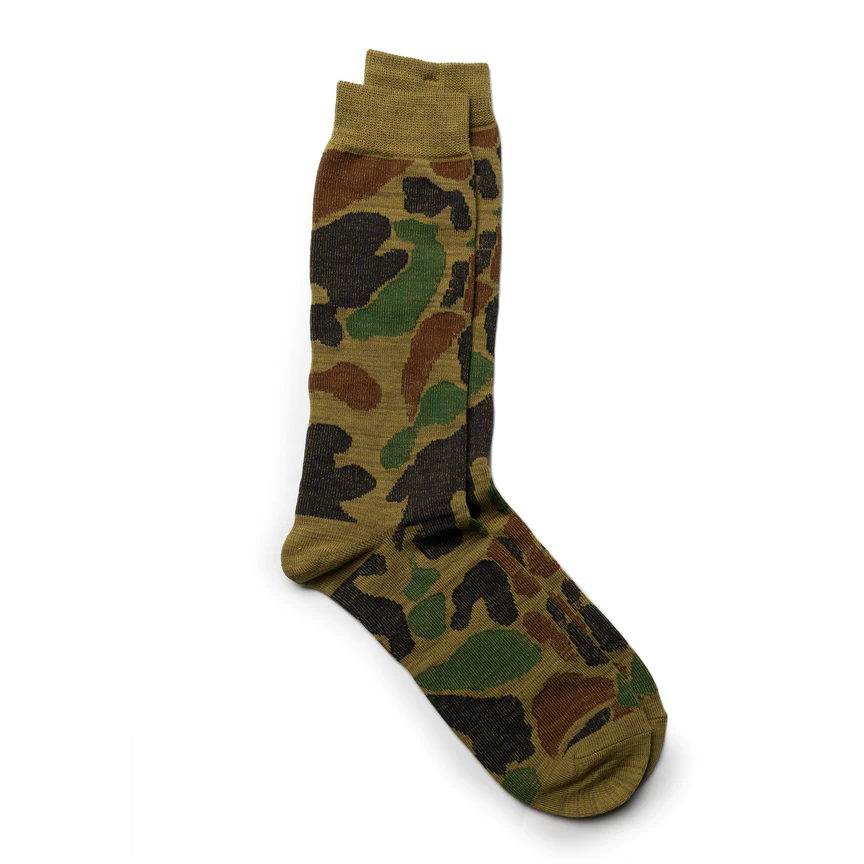 A camouflage-patterned sock in olive and green tones with a ribbed cuff.